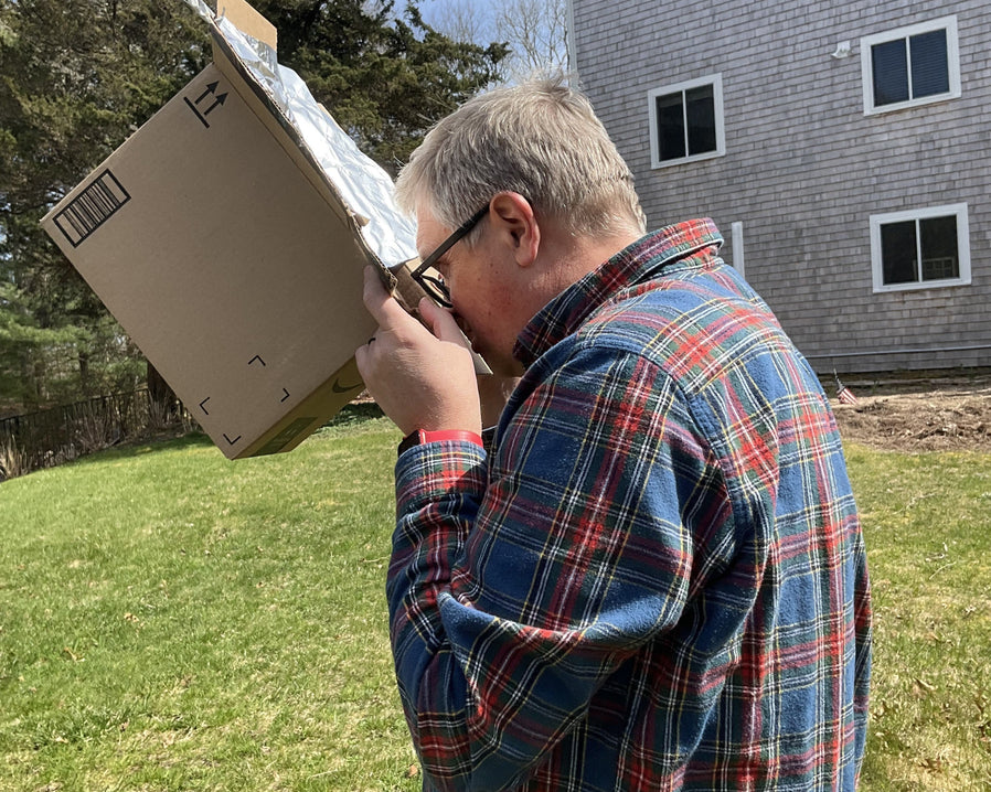 David Mann using pinhole viewer for the 2024 total solar eclipse